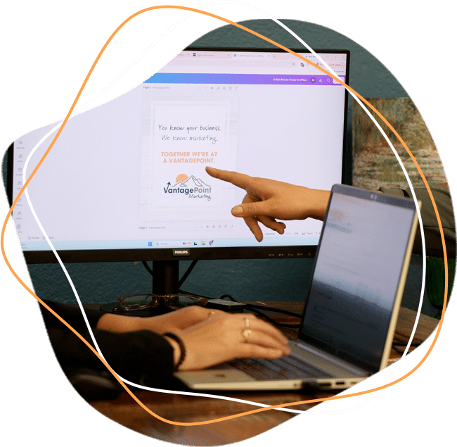 hands pointing at computer