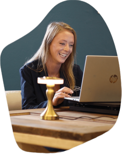 vantage point woman smiling at computer