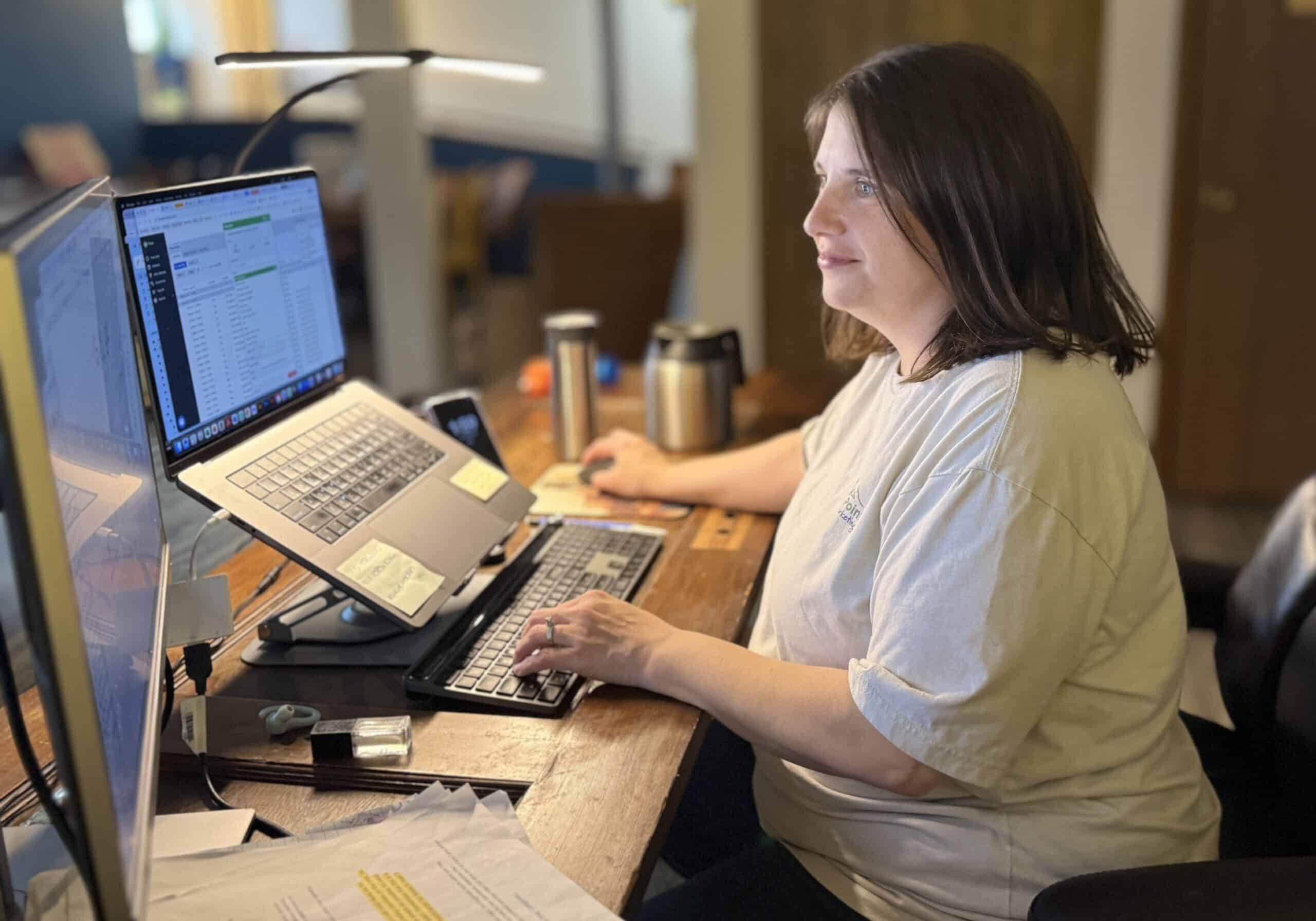jessica swinghammber at a desk working on a laptop